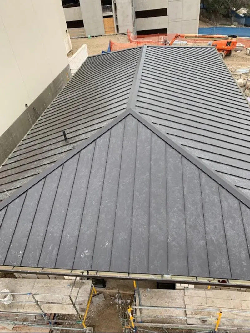 Commercial metal roof construction with crane equipment in Columbia